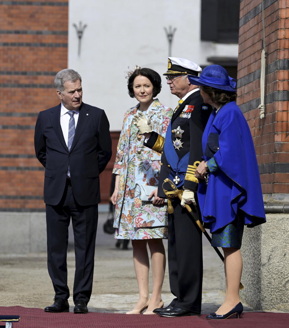 Finland's President Sauli Niinistö, left, and his wife Jenni Haukio are received by Sweden's King Carl Gustaf and Queen Silvia at the Royal Stables in Stockholm Tuesday 17 May. Finland's President Sauli Niinistö and his wife Jenni Haukio will pay a two day long State Visit to Sweden at the invitation of His Majesty The King Carl Gustaf. (Anders Wiklund/TT News Agency via AP)