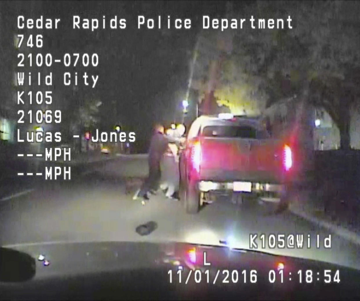 In this image made from a Nov. 1, 2016 dashcam video released Thursday, Dec. 8, 2016, by Cedar Rapids Police Department, an unarmed black motorist struggles with an Iowa officer and a police dog before the driver is shot and paralyzed. The video shows that 37-year-old Jerime Mitchell rushes back to his pickup truck and Cedar Rapids officer Lucas Jones shoots him as the vehicle rolls away. (Cedar Rapids Police Department via AP)