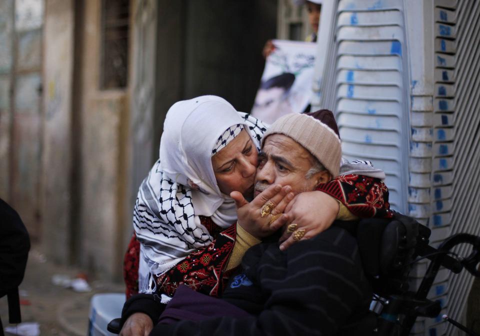 The mother of Palestinian prisoner Barbakh, kisses her brother as they celebrate ahead of his expected release in Khan Younis