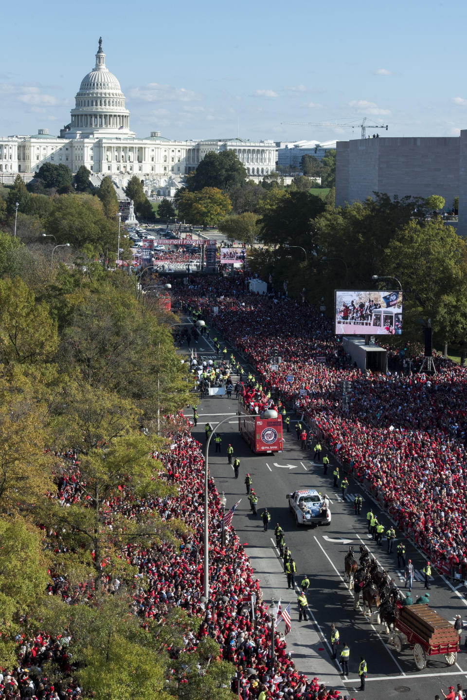 With the Capitol in the background, the MLB Washington Nationals celebrate the team's World Series baseball championship over the Houston Astros, with their fans in Washington, Saturday, Nov. 2, 2019. The Washington Nationals are getting a hero's welcome home from a city that had been thirsting for a World Series championship for nearly a century.(AP Photo/Cliff Owen)