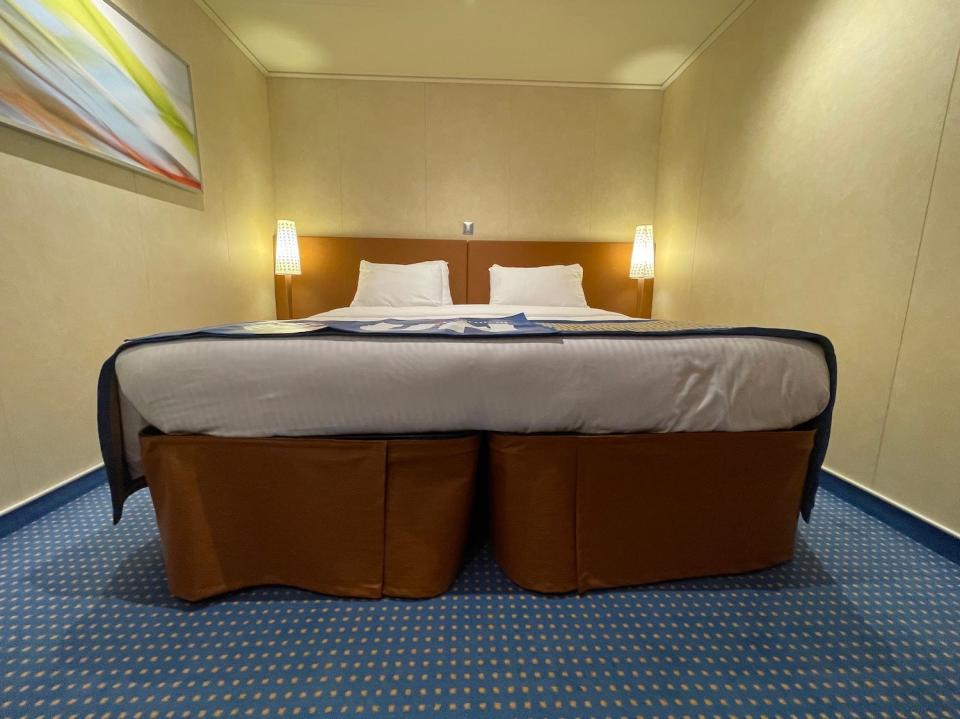 A shot that shows two twin=sized beds. pushed together.