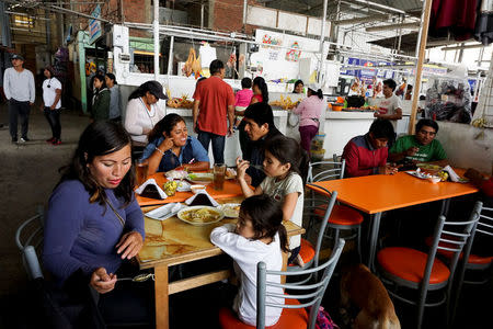 People have lunch at Paradero 4 market, located near Nueva Union shantytown, in Villa Maria del Triunfo district of Lima, Peru, May 23, 2018. REUTERS/Mariana Bazo