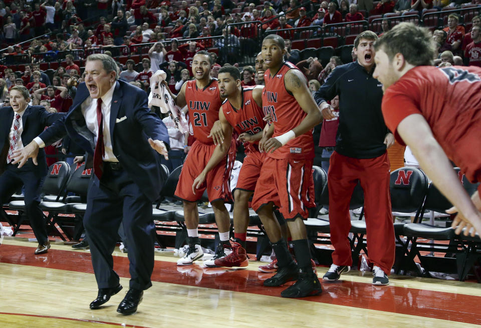 FILE - In this Dec. 10, 2014, file photo, Incarnate Word coach Ken Burmeister, second left, and players on the bench celebrate after Incarnate Word's Kyle Hittle, right, hit the go-ahead basket for a 74-73 win over Nebraska in an NCAA college basketball game in Lincoln, Neb. Burmeister, a college basketball coach for 21 seasons who took Texas-San Antonio to the NCAA Tournament and later guided Loyola of Chicago, died Tuesday, May 19, 2020. He was 72. Loyola said Burmeister died following a bout with cancer. (AP Photo/Nati Harnik, File)