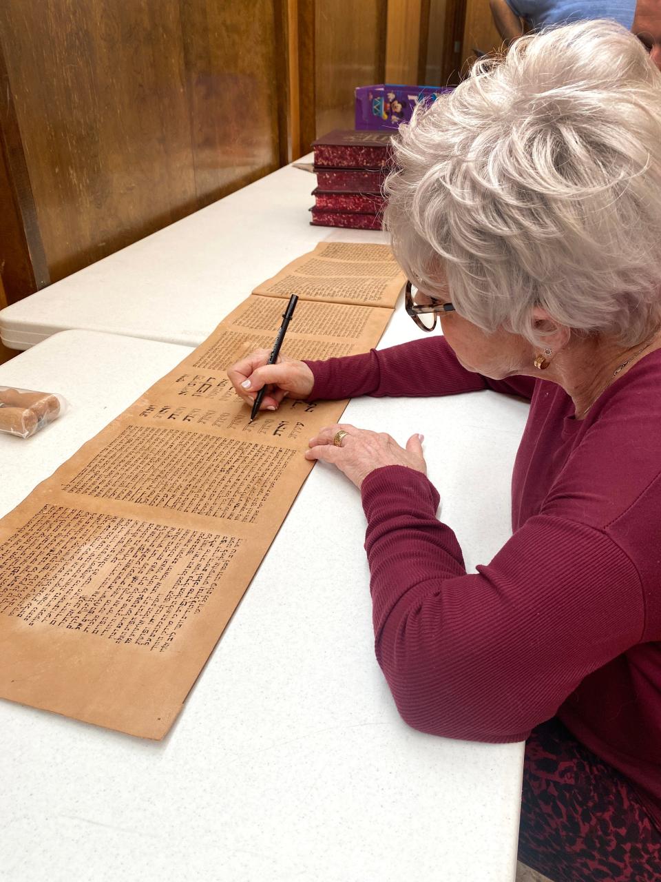 A member of The Kedusha Project based in Oklahoma works on a scroll of the Book of Esther at Emanuel Synagogue in Oklahoma City.