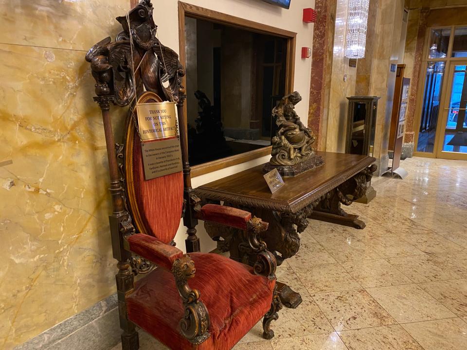 a table and chair located in the back of the congress plaza hotel lobby