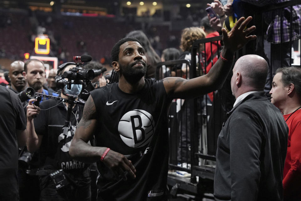 Brooklyn Nets guard Kyrie Irving greets fans after the team's 112-98 win over the Toronto Raptors in an NBA basketball game Wednesday, Nov. 23, 2022, in Toronto. (Chris Young/The Canadian Press via AP)