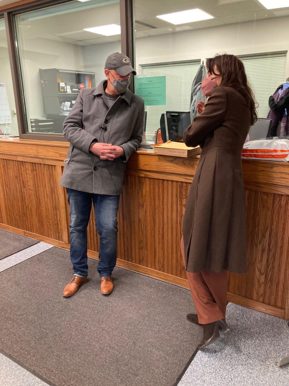 Peter Isely, left, and Sarah Pearson, right, wait to hear whether somebody from Victim Services will meet with them over the documents that they claim list 69 priests associated with the Diocese of Green Bay as alleged sexual abusers.