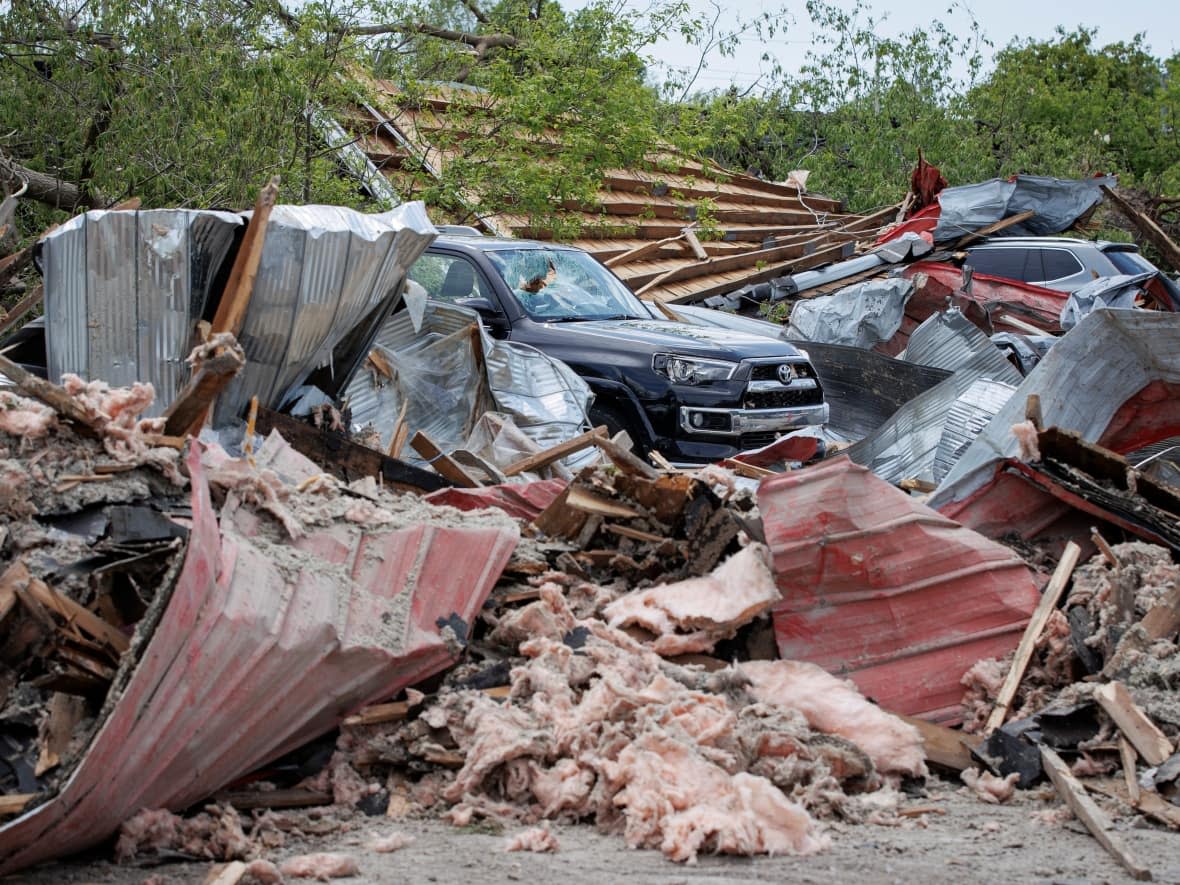 Residents of Uxbridge, Ont., clean up after a severe storm caused significant property damage. Uxbridge, Clarence-Rockland, east of Ottawa, and Peterborough have declared states of emergency due to the extensive damage caused by Saturday's storm. (Evan Mitsui/CBC - image credit)