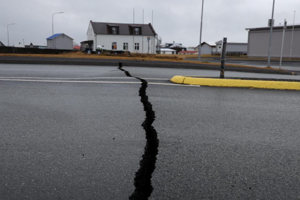 Cracks emerging in the road near Grindavik (via REUTERS)