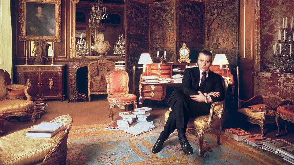 Lagerfeld in his residence in the Hôtel Pozzo di Borgo circa 1990. Across some three decades of his life, Lagerfeld lived in different parts of the building; in outfitting his homes therein, he "returned to the dreams of grandeur and elegance that had been sparked in him as a child," Kalt wrote of Lagerfeld and the <em>ancien regime</em>-worthy aesthetic on display. - Fotex/Shutterstock/Courtesy Thames & Hudson