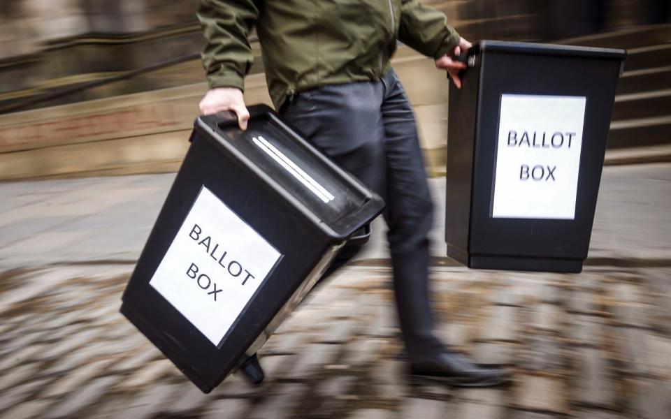 Ballot boxes are carried in Edinburgh  - Credit: Danny Lawson/PA