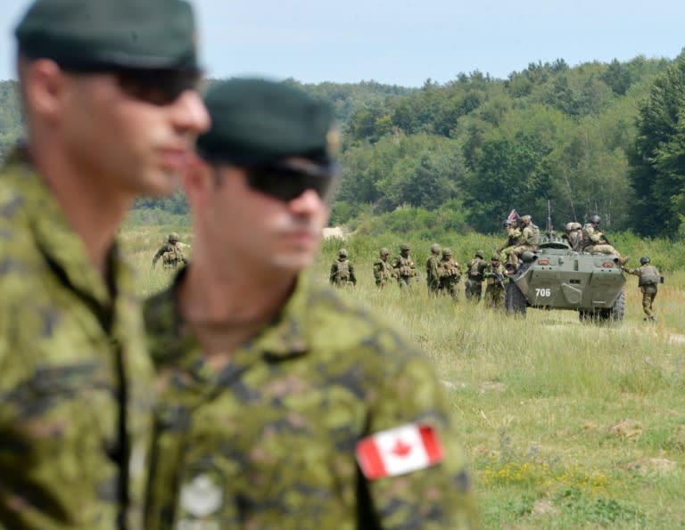 Canadian military instructors look on during Ukrainian military exercises at the International Peacekeeping and Security Center in Yavoriv, near Lviv, on July 12, 2016