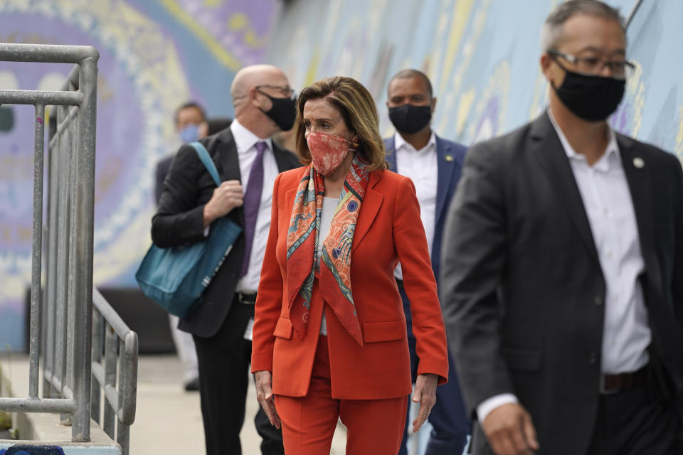 House Speaker Nancy Pelosi walks with her staff to a news conference at the Mission Education Center Elementary School, Wednesday, Sept. 2, 2020, in San Francisco. Pelosi said she takes responsibility for trusting the word of a San Francisco hair salon she's visited over the years when it told her it was OK to come in for a solo visit this week, even though the city still does not allow indoor beauty services. (AP Photo/Eric Risberg)