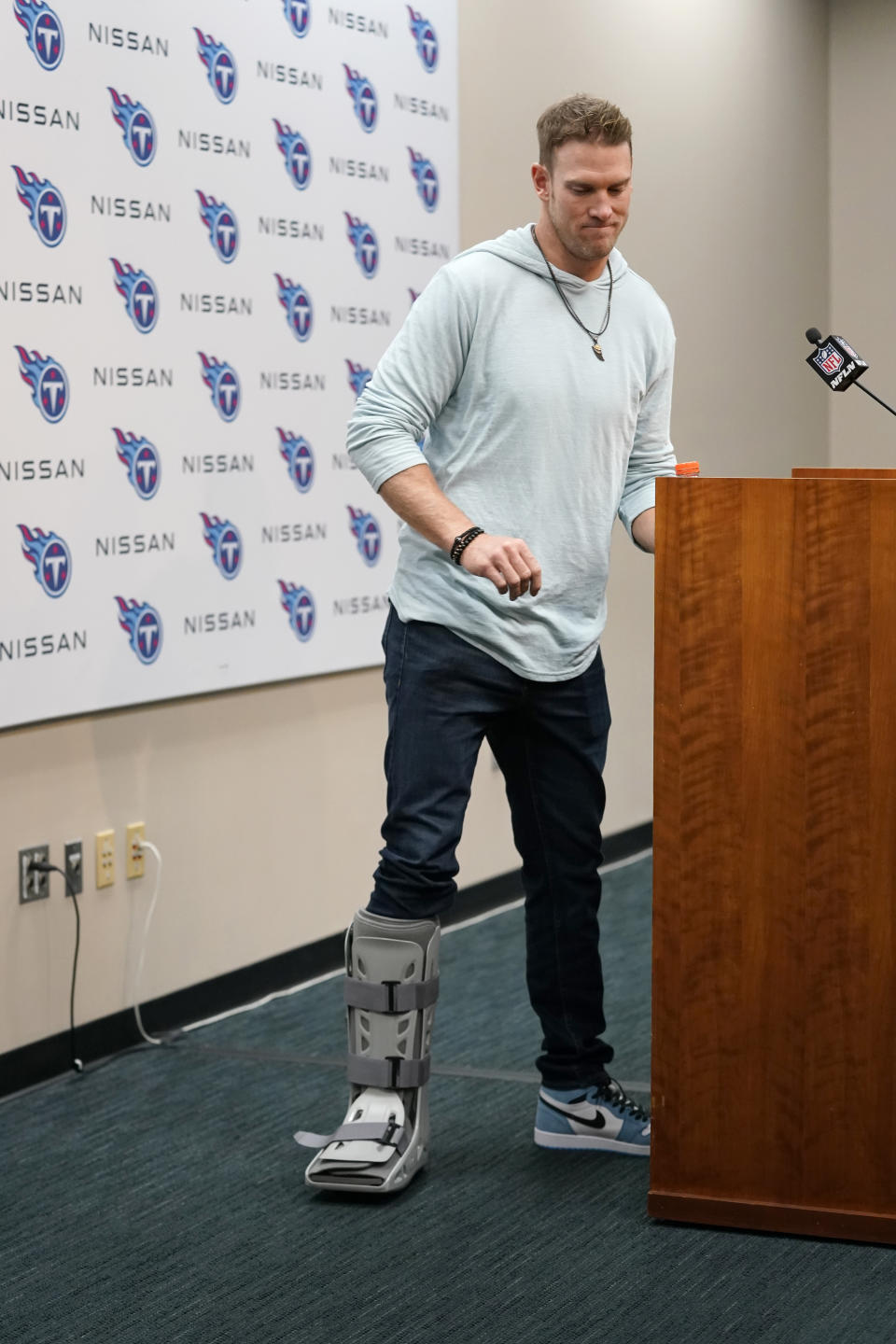 Tennessee Titans quarterback Ryan Tannehill wears a boot on his foot during a news conference following an NFL football game between the Tennessee Titans and the Indianapolis Colts Sunday, Oct. 23, 2022, in Nashville, Tenn. The Titans won 19-10. (AP Photo/Mark Humphrey)