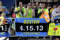 Race fans from left, Andrew Lembecke, of Chicago, Brandon Petrich of Fargo, N.D, Marlene Youngblood of Louisville, Ky, and Bill Januszewski cheer near the finish line at the 118th Boston Marathon Monday, April 21, 2014 in Boston. (AP Photo/Robert F. Bukaty)