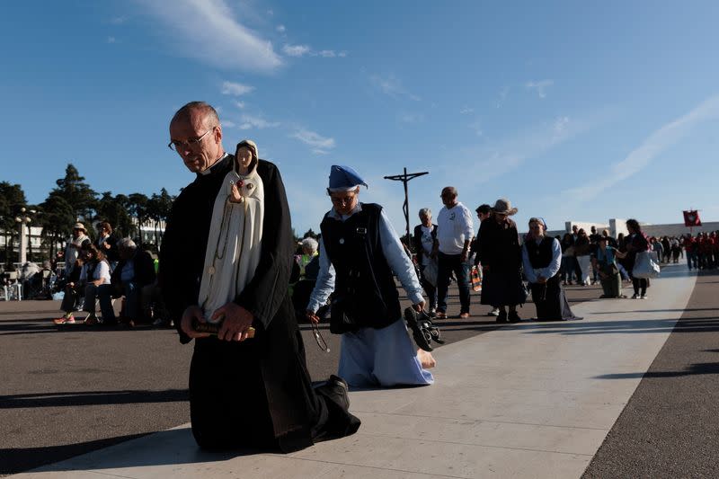 Pilgrims attend the event marking the anniversary of the reported appearance of the Virgin Mary to three shepherd children, at the Catholic shrine of Fatima