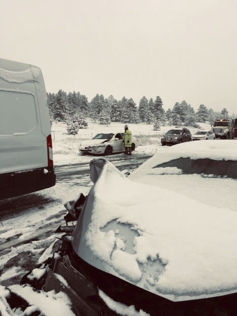 This photo provided by the Ponderosa Fire District shows a multiple car accident caused by slick roads from a snow fall near Flagstaff, Ariz. on Thursday, May 23, 2019. Northern Arizona is getting a rare dose of late-season snow. The National Weather Service is recording snow in the inches near Flagstaff, in Seligman and at the Grand Canyon's South Rim. (Erin Hudman/Ponderosa Fire District via AP)