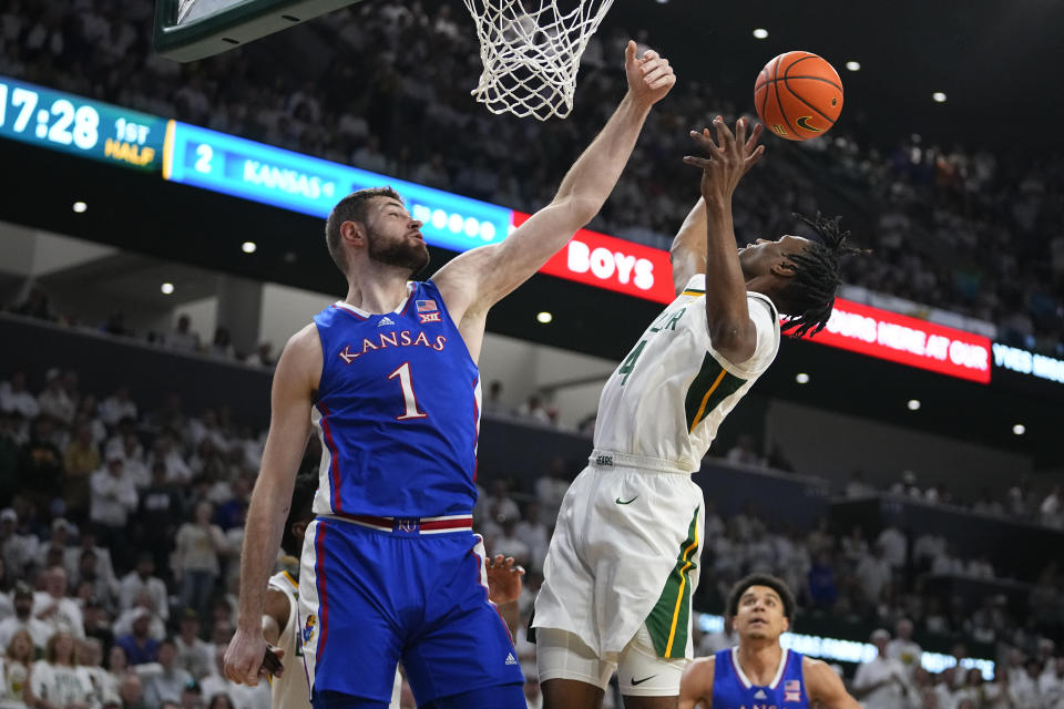 Kansas's Hunter Dickinson (1) blocks a shot by Baylor's Ja'Kobe Walter (4) during the first half of an NCAA college basketball game, Saturday, March 2, 2024, in Waco, Texas. (AP Photo/Julio Cortez)