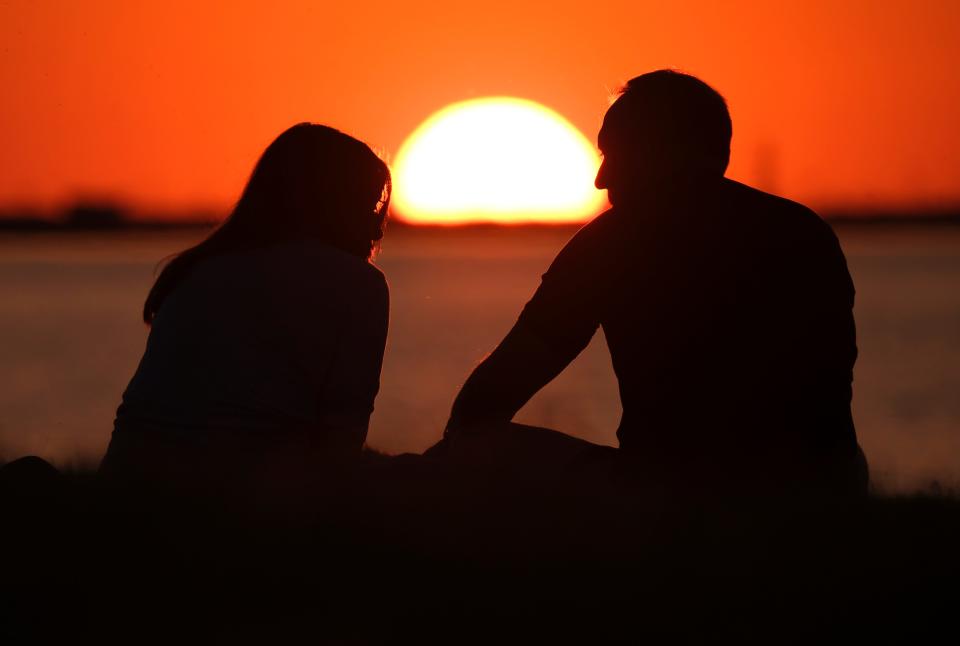 People enjoy the sunset at Lake Hefner on May 10.