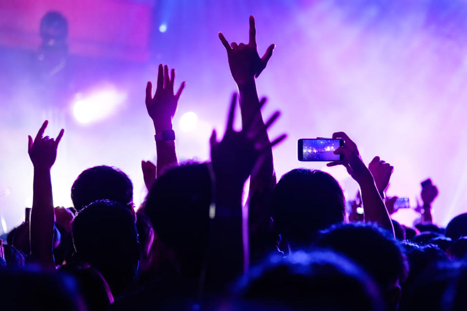 Silhouettes of people enjoying a concert (baona / Getty Images)