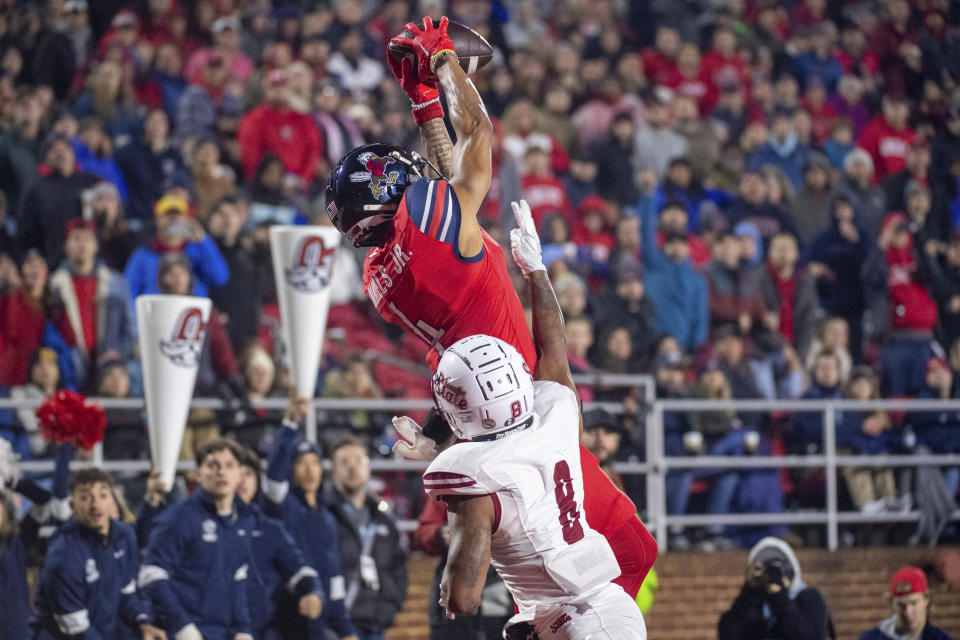 Liberty's CJ Daniels makes a reception over New Mexico State's Andre Seldon during the second half of the Conference USA championship NCAA college football game Friday, Dec. 1, 2023, in Lynchburg, Va. (AP Photo/Robert Simmons)