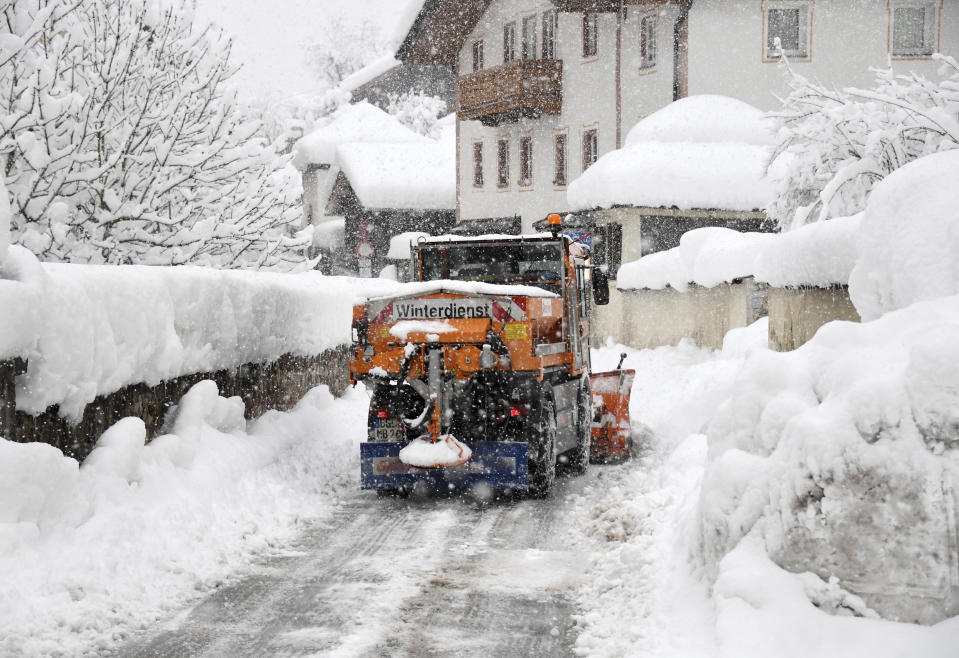 A snow plough cleans a street in Berchtesgaden, southern Germany, Thursday, Jan. 10, 2019 after large parts of southern Germany and Austria were hit by heavy snowfall. (Tobias Hase/dpa via AP)