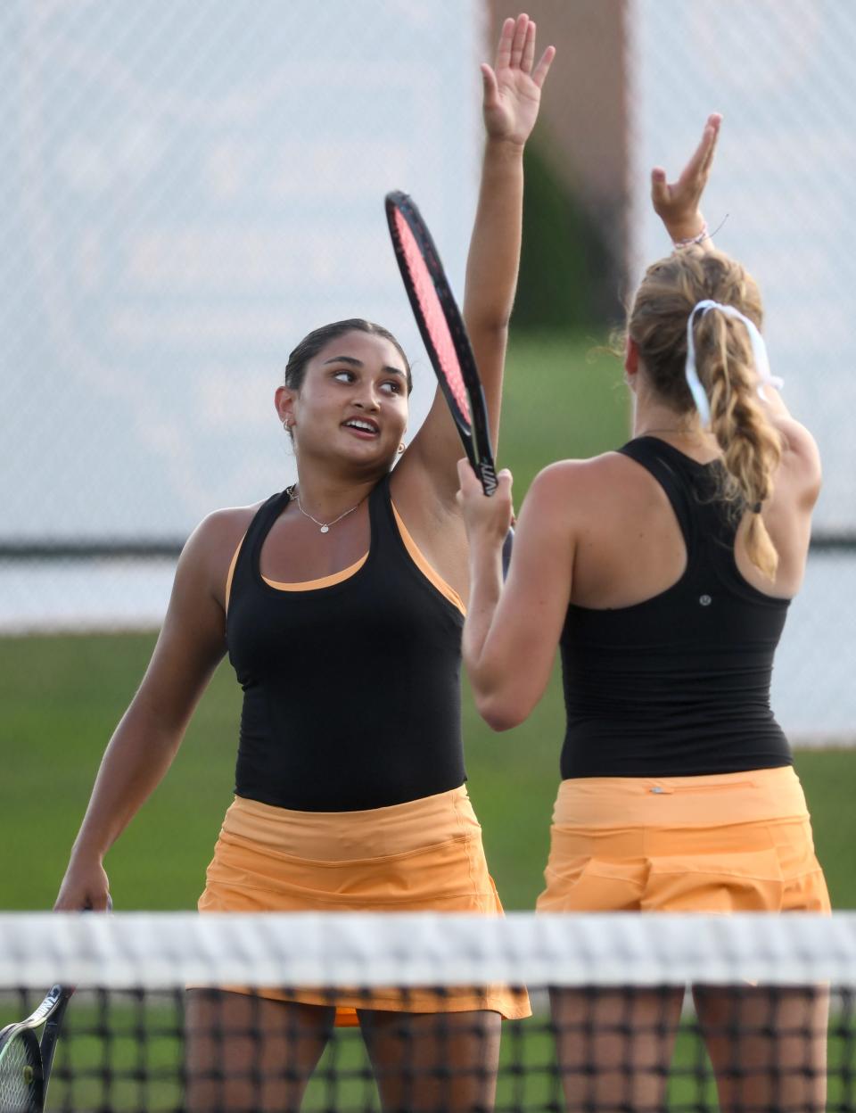 Hoover doubles team of Nyla Spangler and Bridget Fink celebrate a point against Jackson's Ashley Helle and Alex McCann, Tuesday, Sept. 5, 2023.