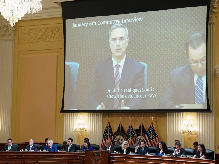 Former White House counsel Pat Cipollone appears on a video display above the House January 6 committee.