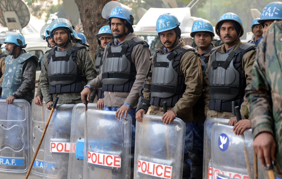 Indian Rapid Action Force personnel in riot gear keep watch during a demonstration following the death of a gang rape victim in New Delhi on December 31, 2012. (RAVEENDRAN/AFP/Getty Images)