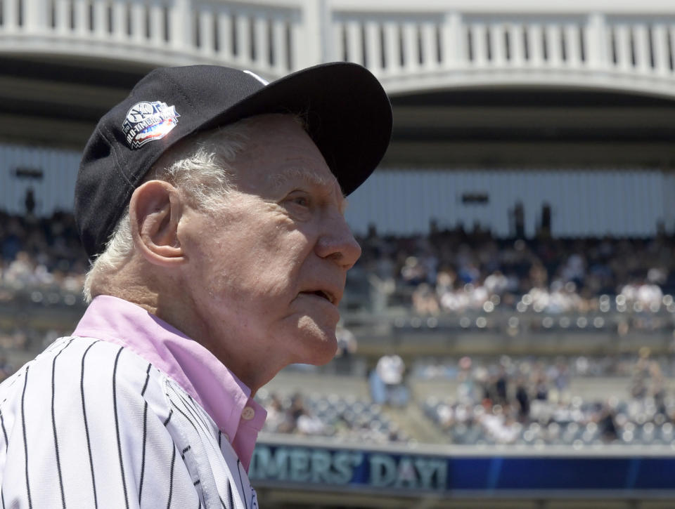 Whitey Ford in the foreground with the fences of Yankees Stadium in the back.