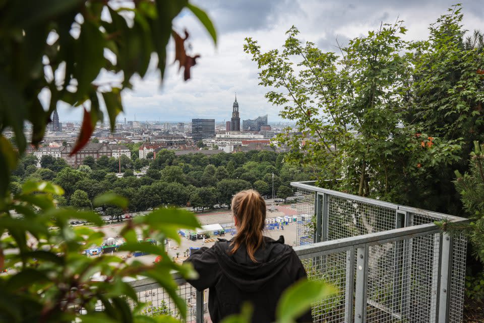 person looking over at the view of Hamburg from Bunker St. Pauli.