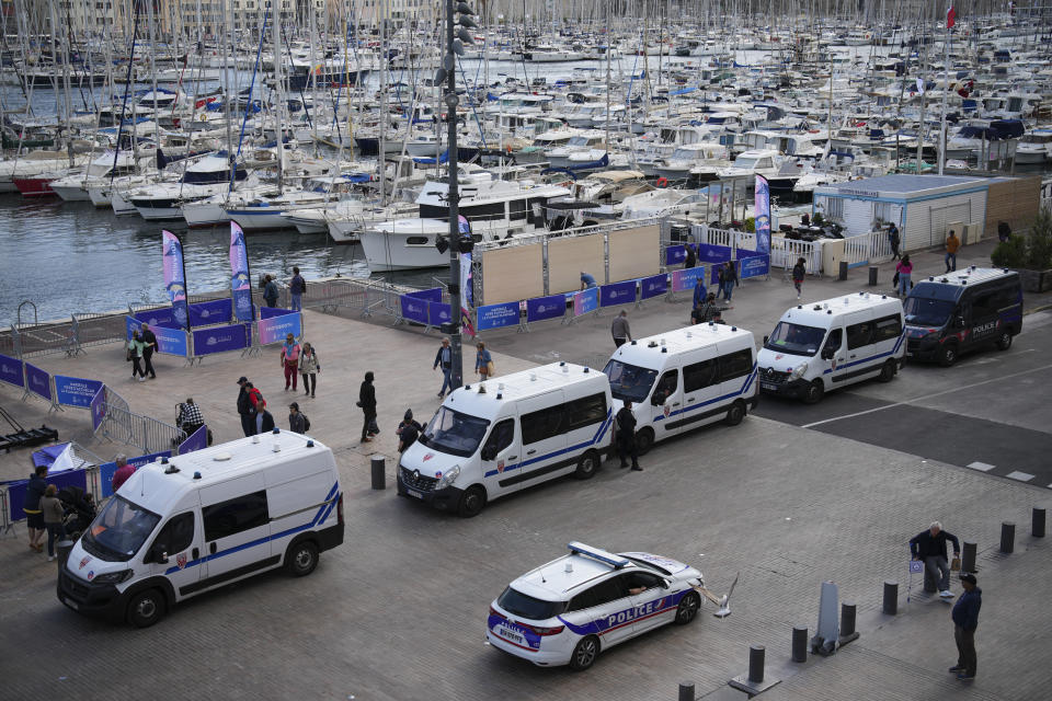 Police patrol before the arrival of the Olympic flame in the Old Port of Marseille in southern France, Tuesday, May 7, 2024. The Olympic torch will finally enter France when it reaches the southern seaport of Marseille on Wednesday. (AP Photo/Daniel Cole)