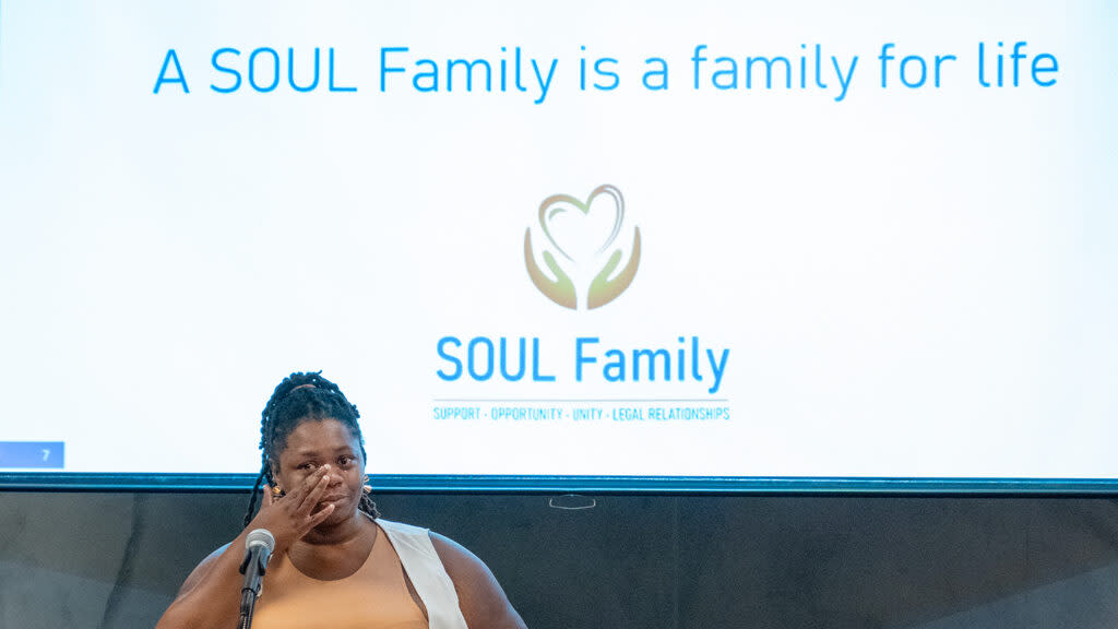 Alexandria Ware, a veteran of the Kansas foster care system, wipes away tears while speaking May 14, 2024, at the Topeka and Shawnee County Public Library during a celebration of SOUL Family legislation