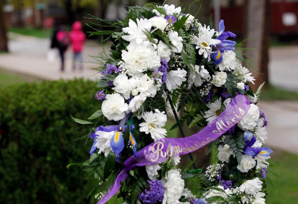 Community members place a wreath outside Hi-Mount Community School in honor of Alexis Patterson in 2013.