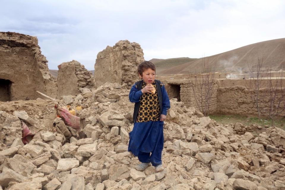 A boy stands near to his damaged house after it was hit by an earthquake in a remote western province of Badghis, Afghanistan last week (Abdul Raziq Saddiqi/AP) (AP)