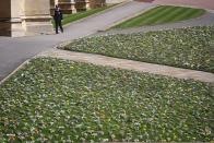 <p>Flower tributes to the Duke of Edinburgh are laid out on the lawn. </p>