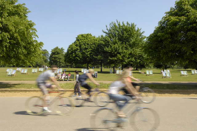 Cyclists enjoy the sun in Hyde Park, London.