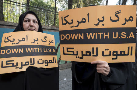 FILE PHOTO: Women hold anti-U.S. banners during a demonstration outside the former U.S. embassy in Tehran November 4, 2015. REUTERS/Raheb Homavandi/TIMA/File Photo