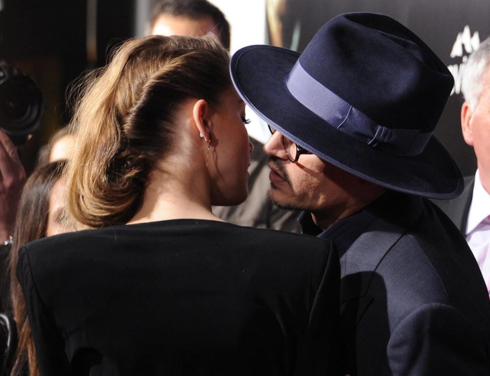 February 12, 2014 <br><br>Johnny Depp leans in for a kiss with Amber Heard as they arrive for the US premiere of <i>3 Days To Kill</i> in Los Angeles, CA, USA (AFP/Getty Images)