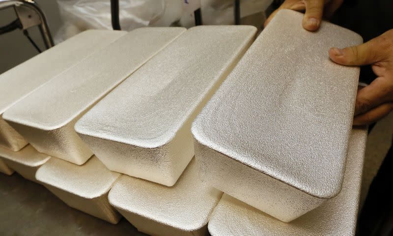 FILE PHOTO: An employee places ingots of 99.99 percent pure silver on a cart at the Krastsvetmet non-ferrous metals plant in Krasnoyarsk