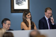 Brooke Lampley, chairman & worldwide head of sales for Global Fine Art at Sotheby's, center, speaks on the phone with a buyer during an auction of Pablo Picasso's master works at the Bellagio hotel and casino Saturday, Oct. 23, 2021, in Las Vegas. Sotheby's and the MGM Resorts Fine Art Collection hosted the auction, which raised $109 million from eleven pieces. (AP Photo/Ellen Schmidt)