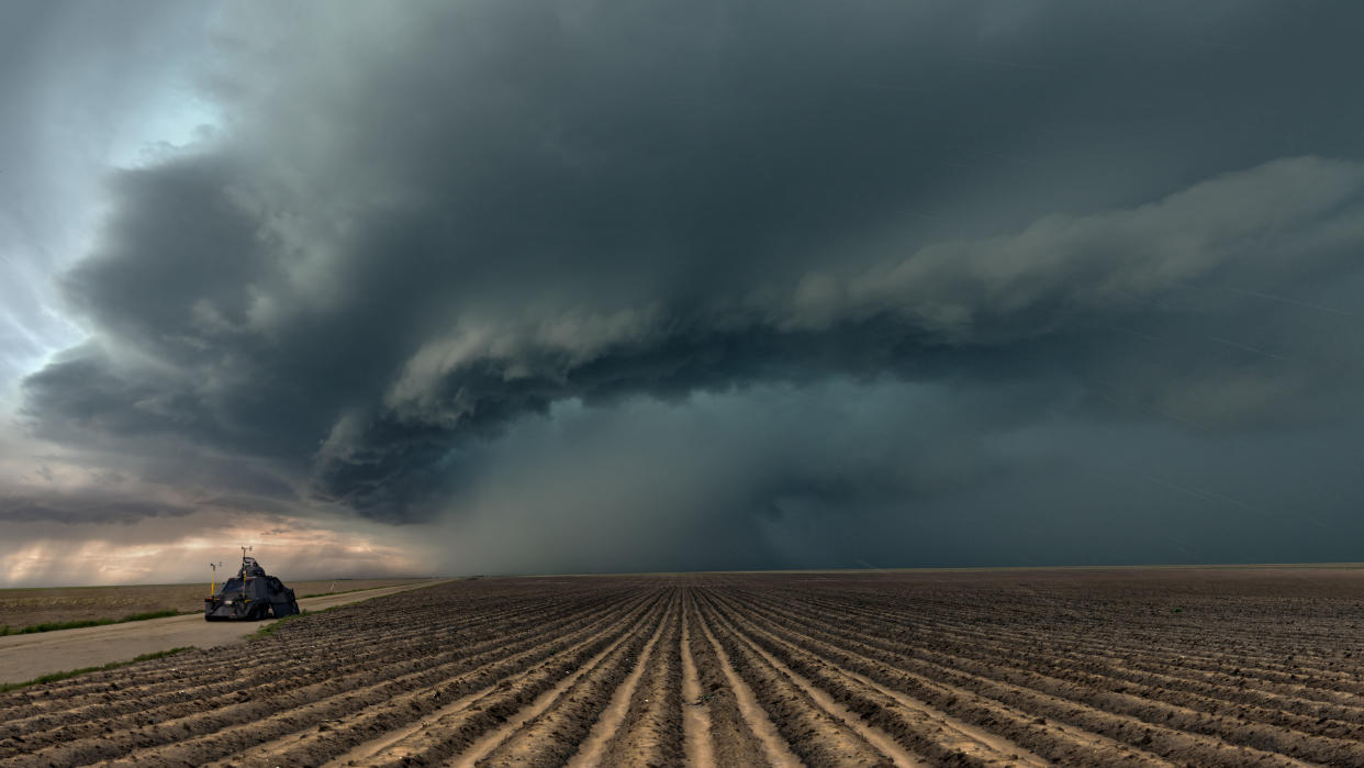 Extreme weather in tornado alley with the famous Tornado Intercept Vehicle. these vehicles are designed to cope with the dangerous winds and debris of tornadoes, up to EF3 strength. Seen here with a severe thunderstorm moving across farmland in  Colorado with hailstones falling.