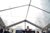 In this June 19, 2013 photo, Donald Trump addresses a gathering to announce the building of Trump International Hotel and Tower in downtown Vancouver, British Columbia, Canada. The 69-story tower has drawn praise for its sleek, twisting design. Prices for the condominiums have set records. But the politics of President Donald Trump have caused such outrage that the mayor won’t attend the Feb. 28 grand opening and has lobbied for a name change. (Jonathan Hayward/The Canadian Press via AP)