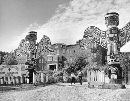 Students walk on the driveway between two totel poles at St. Michael's Indian Residential School in Alert Bay, British Columbia in a 1970 archive photo. REUTERS/Department of Citizenship and Immigration-Information Division/Library and Archives Canada/PA-185533handout