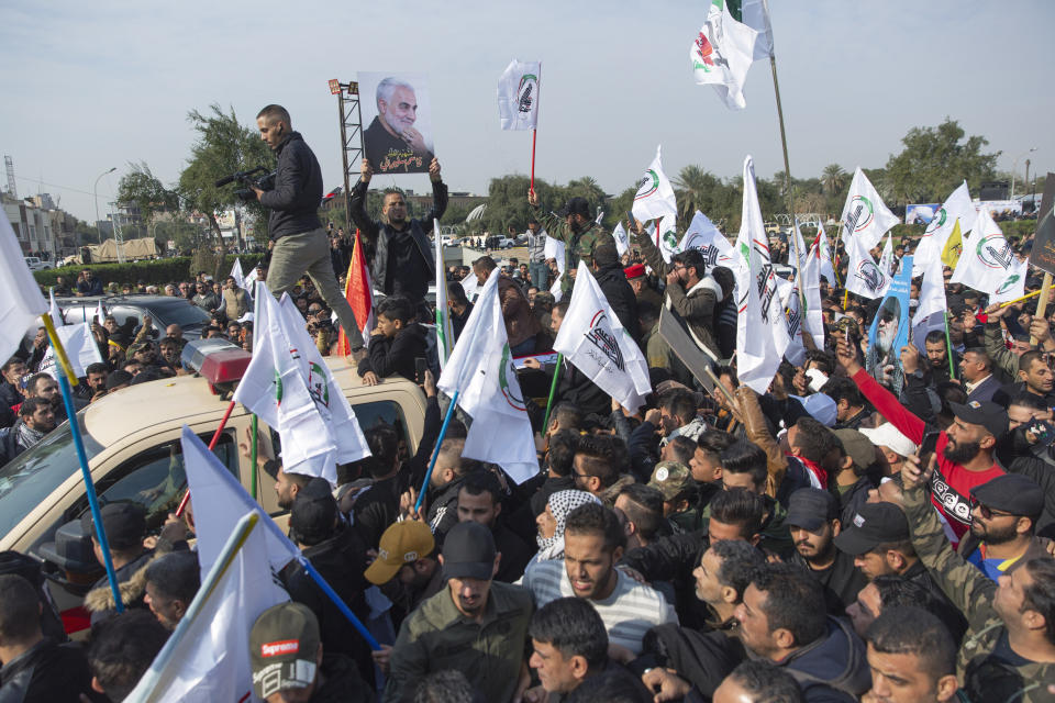 Mourners march during the funeral of Iran's top general Qassem Soleimani, 62, Abu Mahdi al-Muhandis, deputy commander of Iran-backed militias in Iraq known as the Popular Mobilization Forces and fellow militant leaders, in Baghdad, Iraq, Saturday, Jan. 4, 2020. Thousands of mourners chanting "America is the Great Satan" marched in a funeral procession Saturday through Baghdad for Iran's top general and Iraqi militant leaders, who were killed in a U.S. airstrike. (AP Photo/Nasser Nasser)