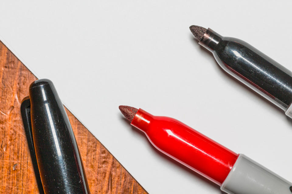 Red and black sharpie felt tip pens viewed close up on the ends