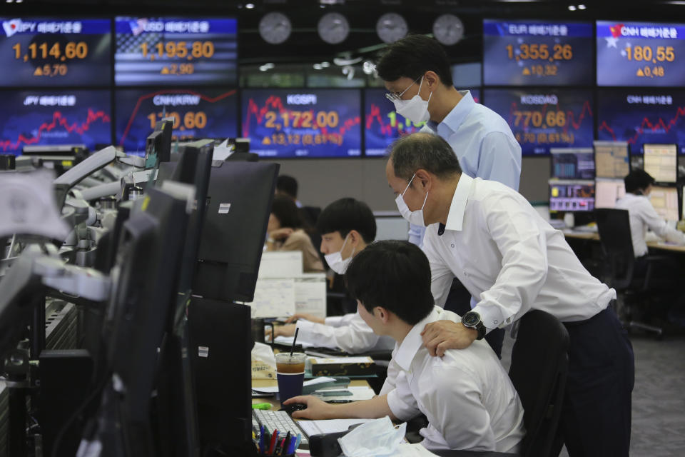 Currency traders watch monitors at the foreign exchange dealing room of the KEB Hana Bank headquarters in Seoul, South Korea, Thursday, July 9, 2020. Asian stock markets followed Wall Street higher on Thursday following gains for major U.S. tech stocks. (AP Photo/Ahn Young-joon)