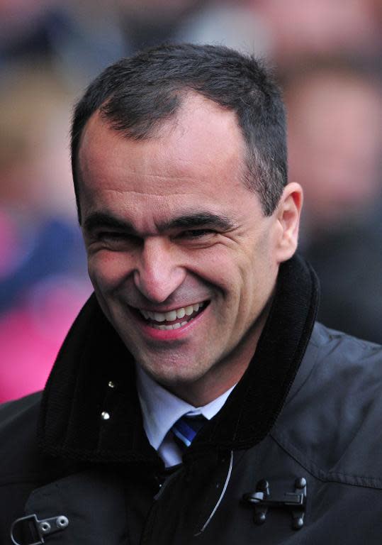 Everton's Spanish manager Roberto Martinez laughs before the start of his side's English Premier League match against Tottenham Hotspur at White Hart Lane in London, on February 9, 2014