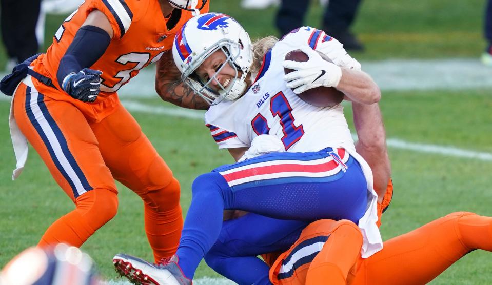 Buffalo Bills wide receiver Cole Beasley (11) is tackled after a catch against the Denver Broncos during the first quarter at Empower Field at Mile High.