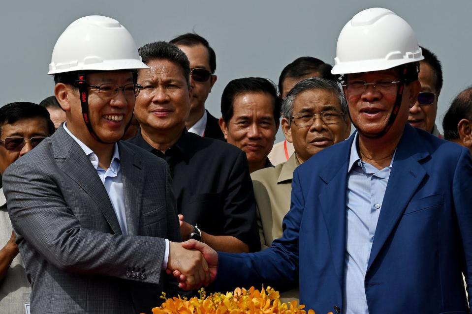 Cambodia Prime Minister Hun Sen shakes hands with China’s ambassador to Cambodia, Wang Wentian. <a href="https://www.gettyimages.com/detail/news-photo/cambodias-prime-minister-hun-sen-shakes-hands-with-chinas-news-photo/1258495631?adppopup=true" rel="nofollow noopener" target="_blank" data-ylk="slk:Tang Chhin Sothy/AFP via Getty Images;elm:context_link;itc:0;sec:content-canvas" class="link ">Tang Chhin Sothy/AFP via Getty Images</a>